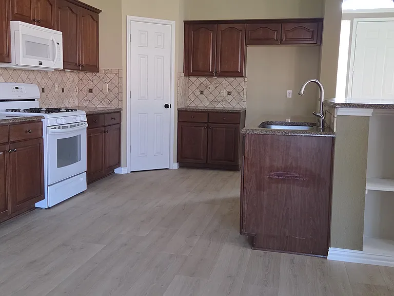 View of kitchen and pantry from breakfast area