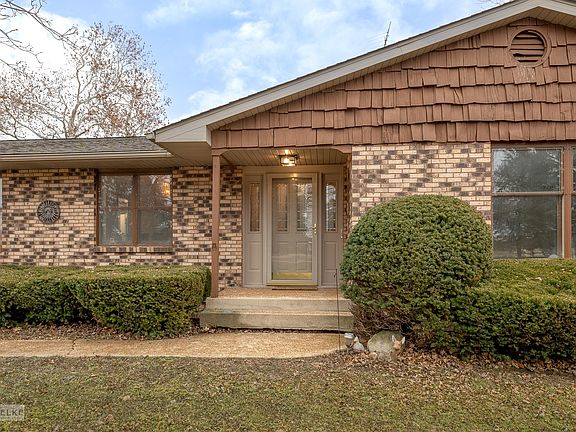 Custom all brick home w/cedar accent & an inviting covered front entrance!