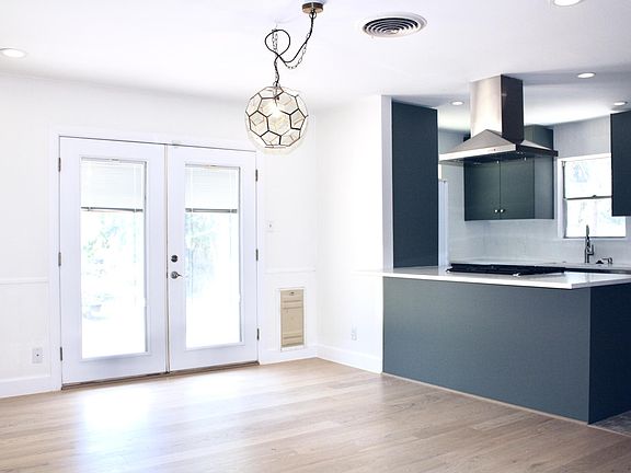 Dining room facing kitchen. Double doors and lockable dog door lead to the backyard.