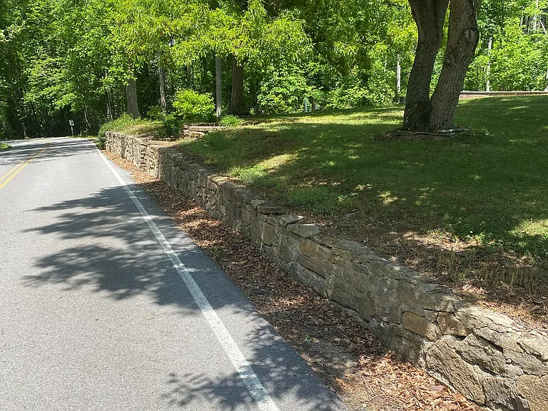 Hand laid creek rock retaining wall mid 1800's.