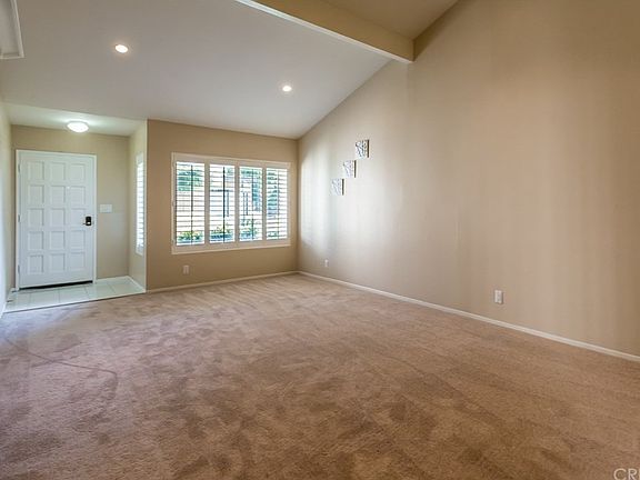 Large front room with shutters, vaulted ceiling &