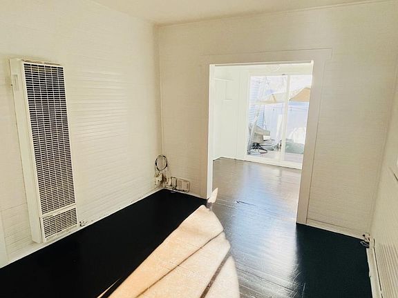 Living room space, viewing from the kitchen/side-door location.