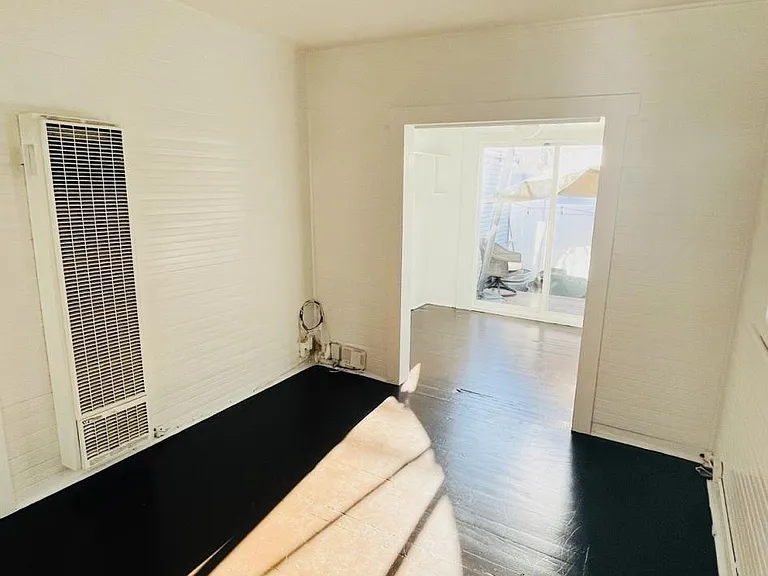 Living room space, viewing from the kitchen/side-door location.