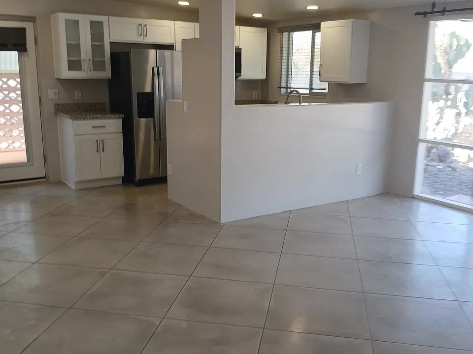 Open kitchen with stainless steel appliances and granite countertops