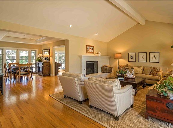 Living Room and Dining Room with views beyond to Family Room entrance and rear yard, viewed from nea