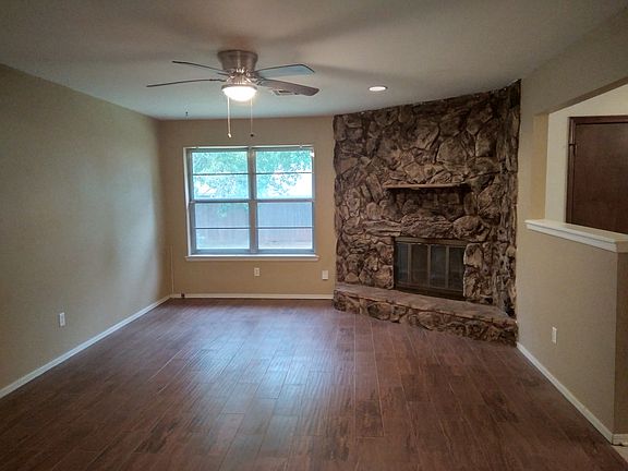 Living room with ceramic tile and gas fireplace.