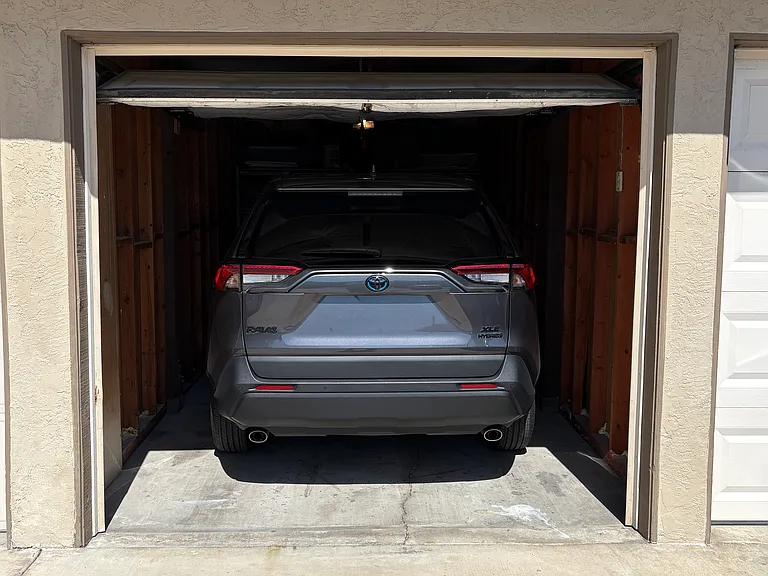 Garage with storage in front of car. Remote (2) and tandem space behind single car garage. RAV4 parked here to show size.
