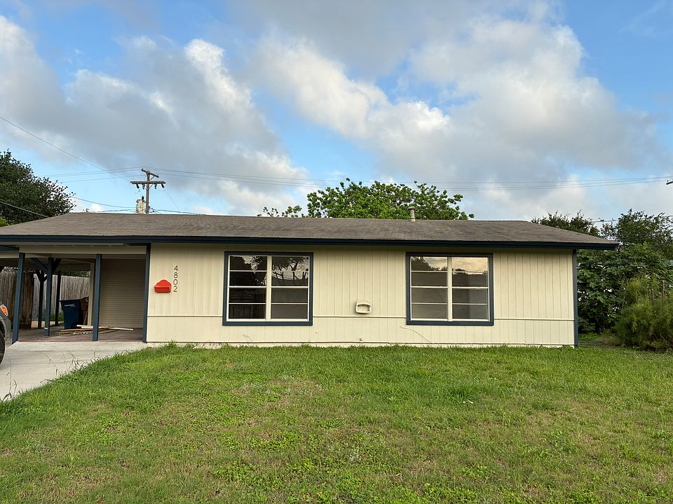 Front of the house with driveway and carport