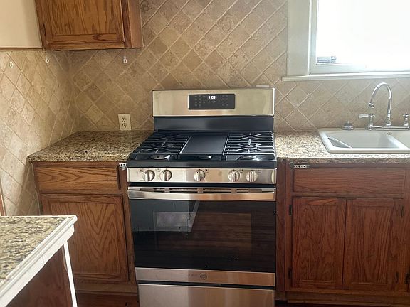 Kitchen: Brand new gas range with center burner