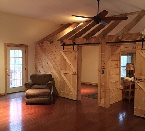 BARN DOORS LEAD TO BEDROOMS