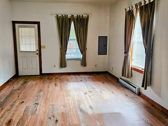 Looking at the front door and living room from the dining area.