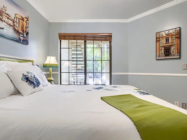 Master Bedroom - Large windows fill the room with natural light, creating a bright and peaceful space designed for restful mornings and relaxing evenings.