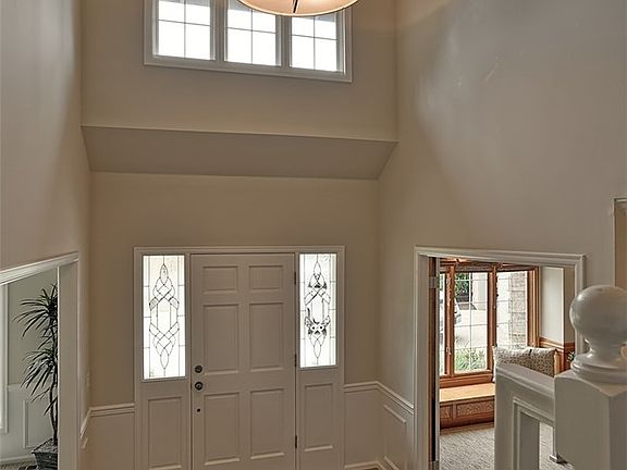 From stairs, formal living room on left & den on right.
