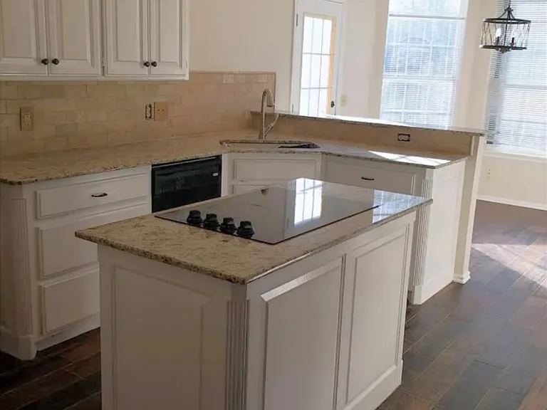 Kitchen island with stove. In the back there is a kitchen nook for a secondary eating area or to be converted to an area for a desk/office. I've seen folks use it for multiple uses.