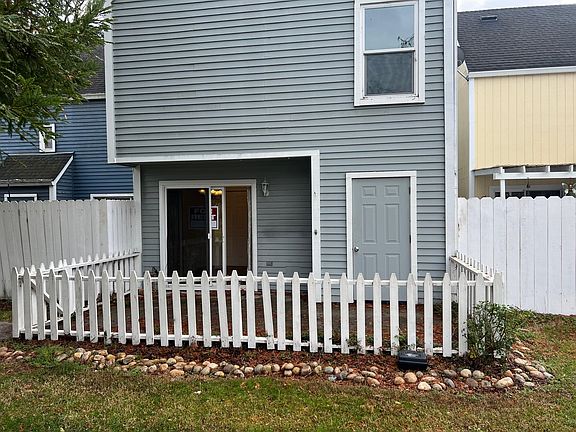 Patio off sliding glass door from kitchen. Storage closet. Looking at Master Bedroom window.