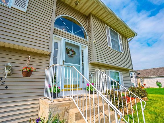 FRONT VIEW OF BEAUTIFUL HOME ON LARGE LOT, UPGRADED FRONT DOOR AND CONCRETE DRIVEWAY!