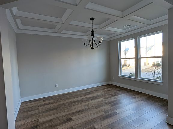 Dinning room with gorgeous coffered ceilings.