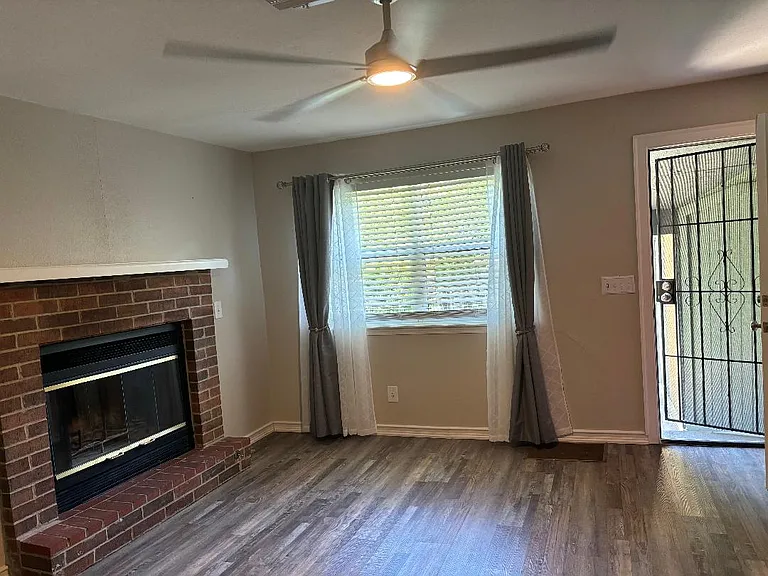 Cozy working fireplace with natural light exterior view.
