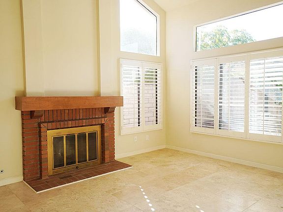 Living room has High ceiling and fireplace.