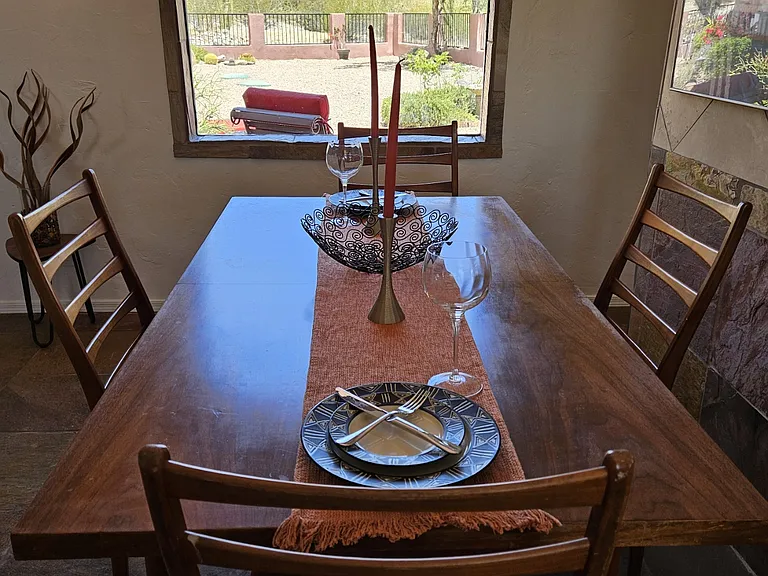 Dining area with back yard and mountain views.