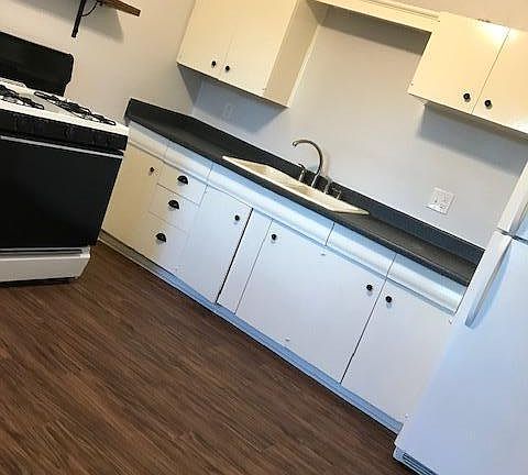 Spacious kitchen large enough to accommodate a table and chairs.