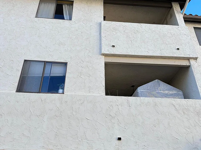 Rear of townhome, 2-car garage. Open Patio, bedroom balcony.