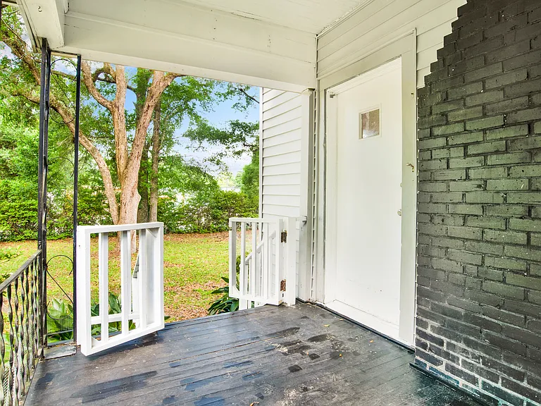 Front porch sitting area and front door.