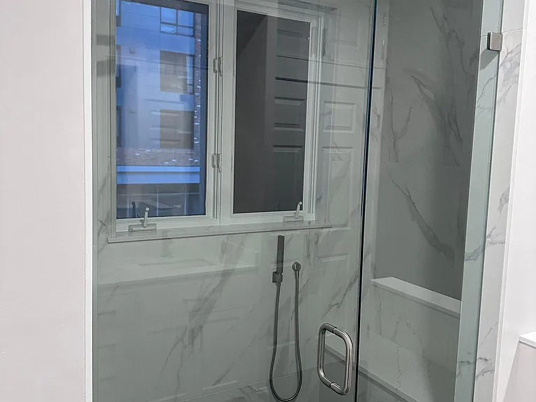 Newly remodeled primary en-suite bathroom with giant walk in-shower with Rain-shower head and handheld.
