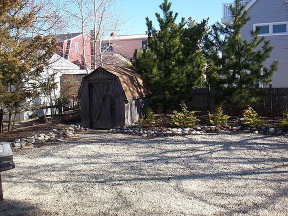 Landscaped yard with shed