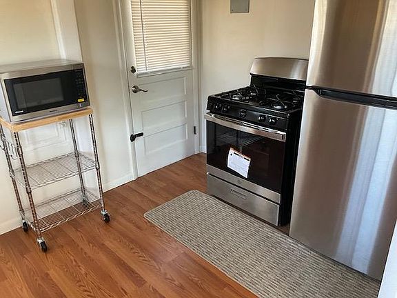 Refrigerator, Gas Stove and Microwave Door to back Patio and Gardening area