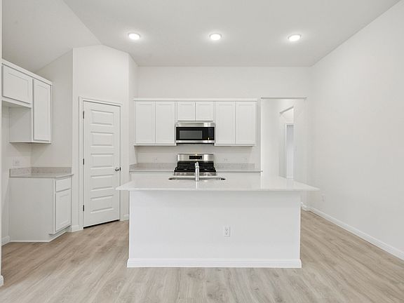 Kitchen in the Cypress home plan by Trophy Signature Homes - REPRESENTATIVE PHOTO