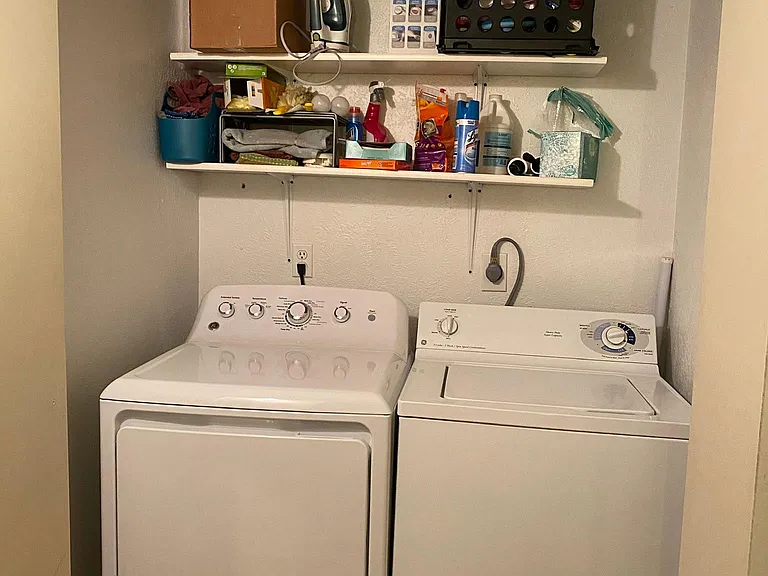Laundry room in hallway with doors open for your own washer/dryer; washer dryer provided if desired (not the ones pictured)