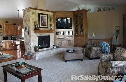 LIVING ROOM
						:
						DOUBLE SIDED FIREPLACE WITH STONE. CUSTOM ENTERTAINMENT CENTER