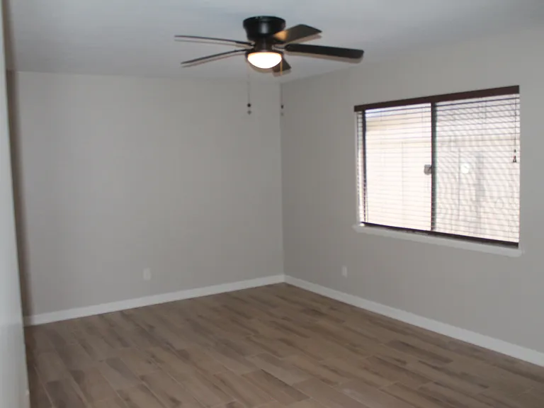 Spacious master bedroom with a large window for natural light