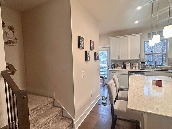 Kitchen area with stairs up to second floor