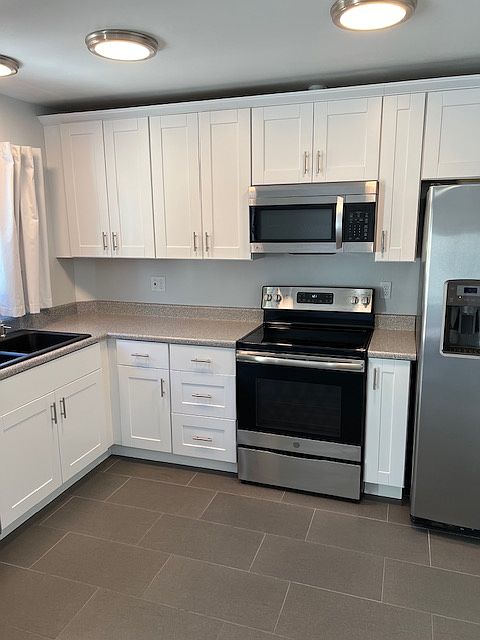 Kitchen, Kitchen Lighting, Granite Sink, Cabinets, Appliances, Tile and Grout Flooring, Newly Painted Ceiling, Walls, Baseboard and Molding.