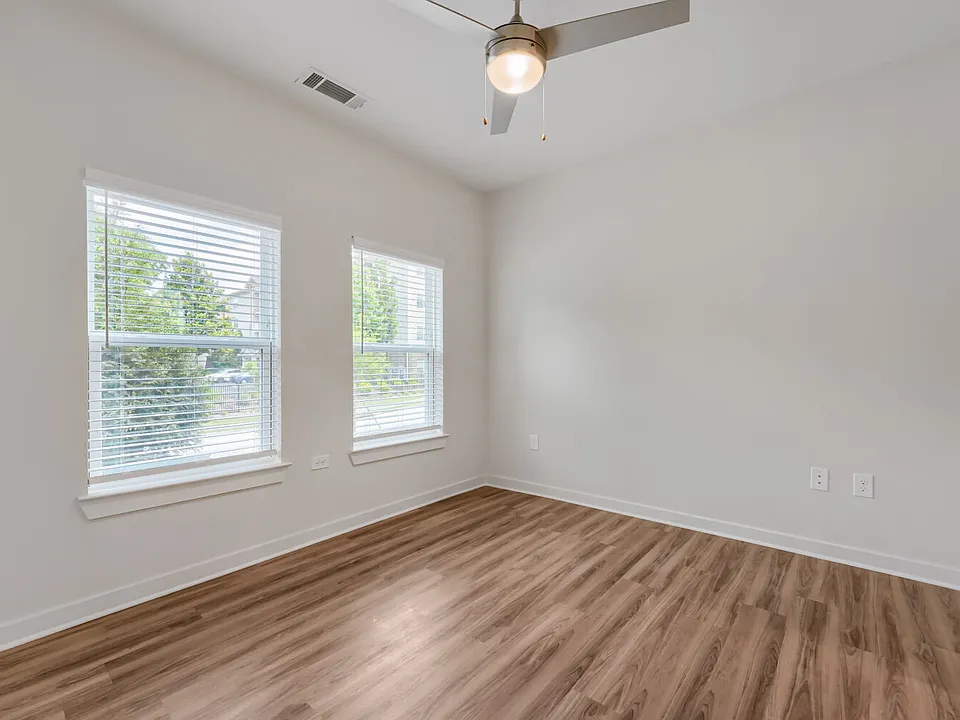 Bedroom with windows and ceiling fan