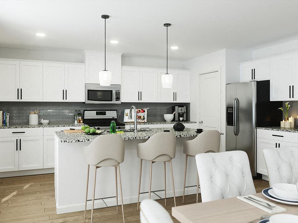 Spacious kitchen with an island, ample storage, and stainless steel appliances.