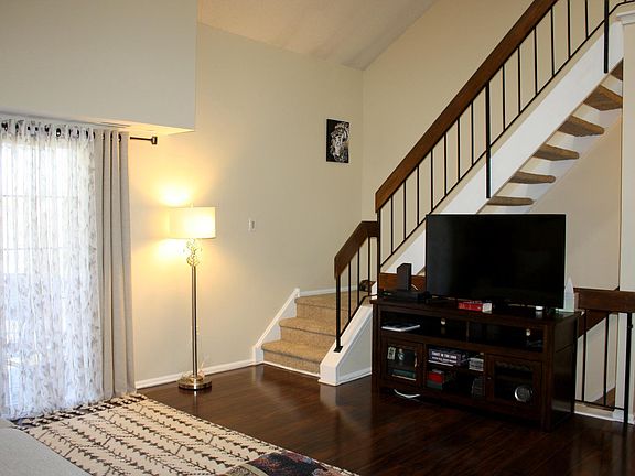 Living room with vaulted ceiling and skylights