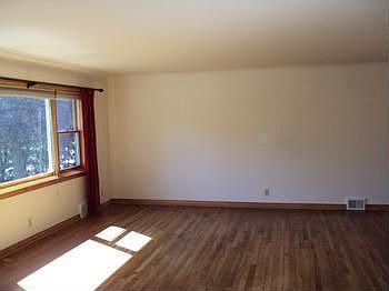 The living room has hardwood flooring.