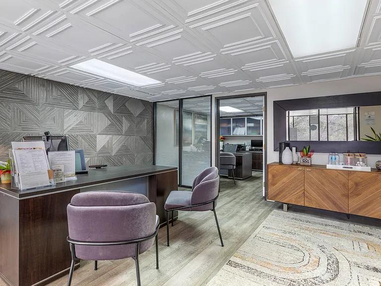 Step into Independence Plaza's chic lobby, featuring plush purple chairs and a welcoming leasing officewhere luxury meets convenience.