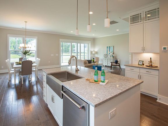 New luxury home kitchen with large center island and a deep bowl sink.
