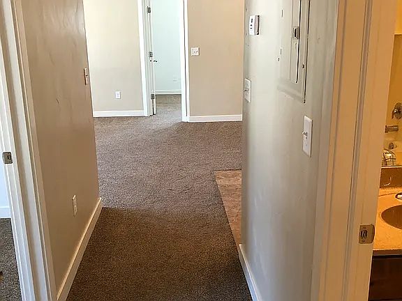 Front door with spare bedroom on Left and Spare Bathroom and Laundry area on Right