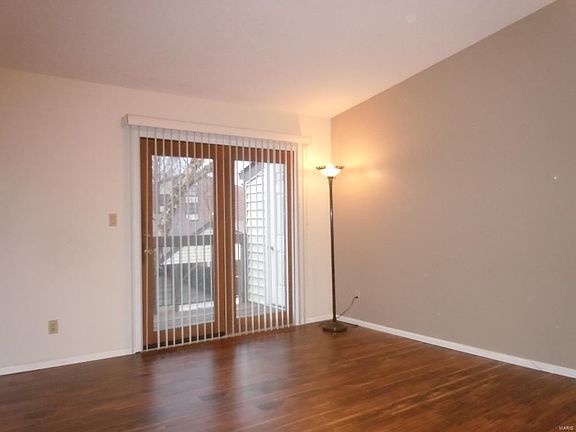 Light filled living area with vaulted ceilings.  Newer paint.