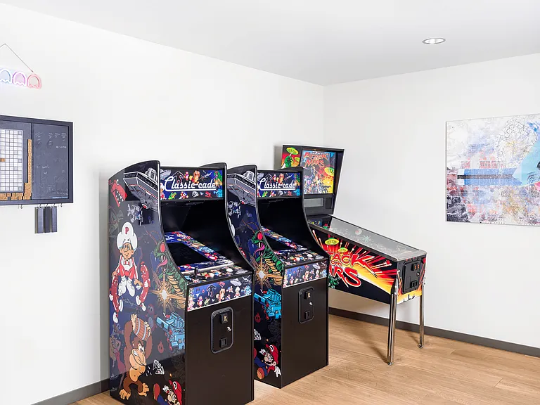 A retro-inspired game room at Modera Belmont, offering classic arcade play.