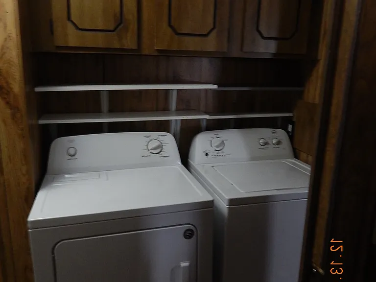 Washer & dryer with cabinetry at top of photo.