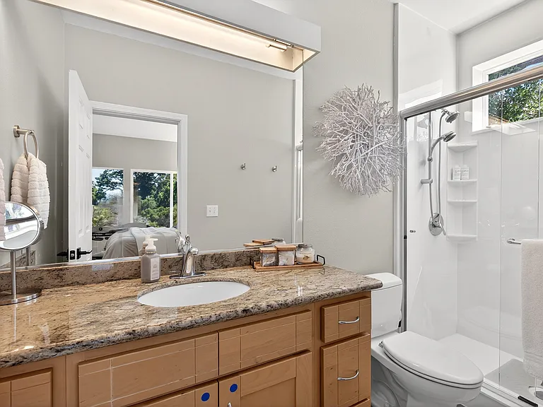 En suite full bath for secondary suite. Location: upstairs/main floor