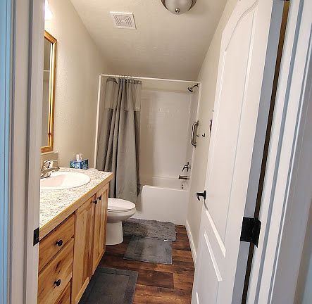 Spacious bathroom with plenty of storage and bath/shower combo.