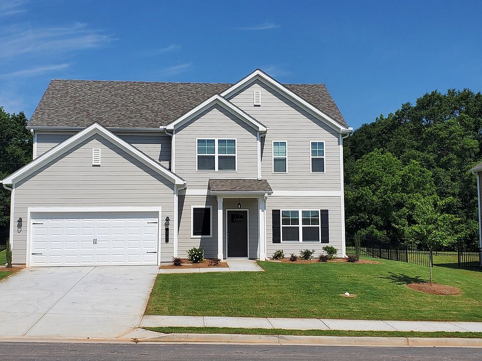 Exterior shot of the two story homes with private driveways and attached garages.