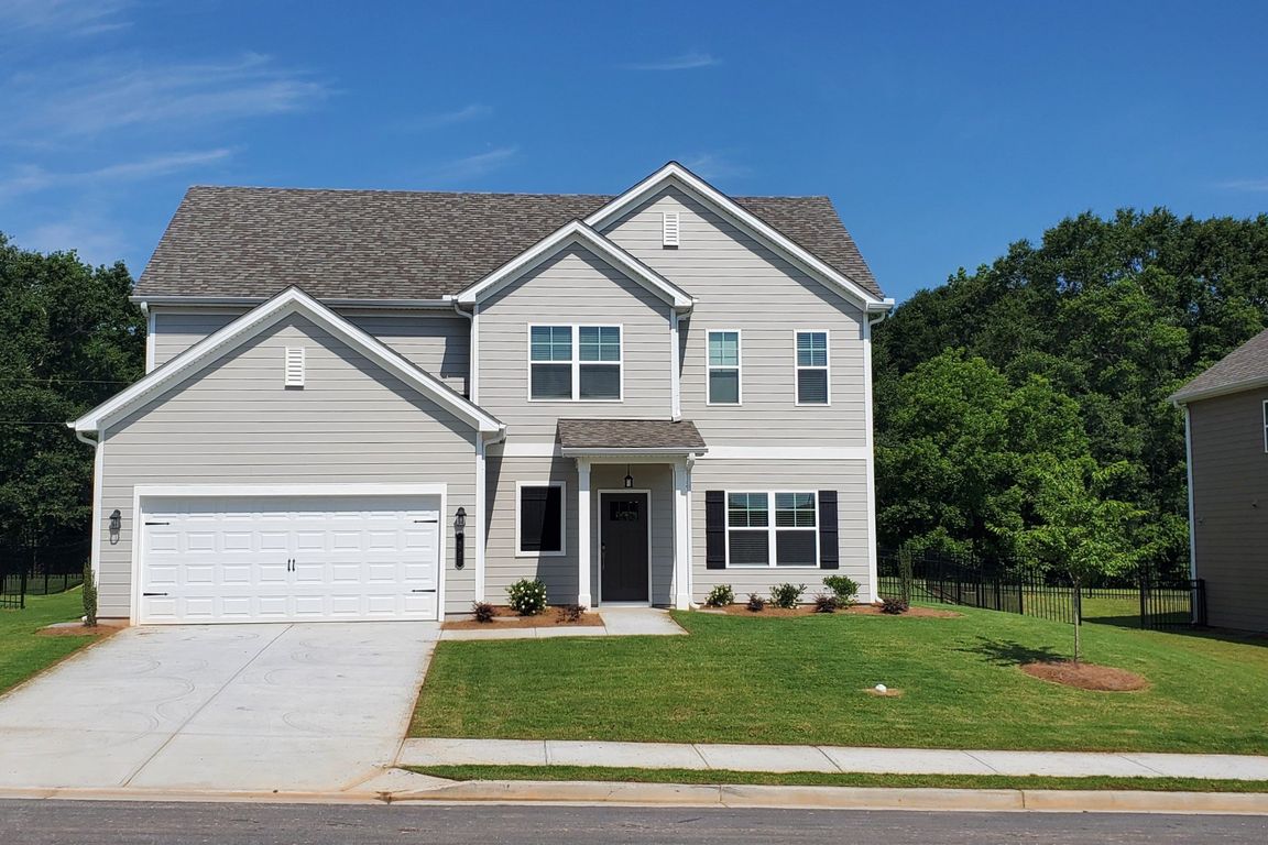 Exterior shot of the two story homes with private driveways and attached garages.